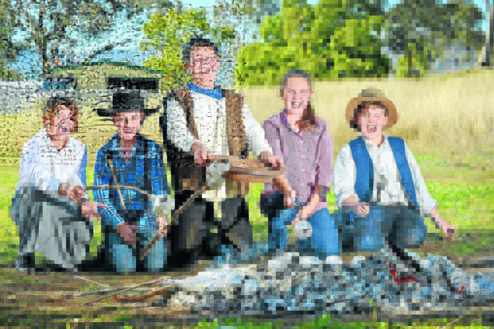 UNCOVERING HISTORY TREASURE: Isis Lumby from Year 6, Ethan Fletcher of Year 5, Patrick Staniland from Year 6, Jessica Froud from Year 6 and Logan Cross from Year 5 panning up gold, as well as damper and golden syrup. Photo: Barry Smith 280515BSA04