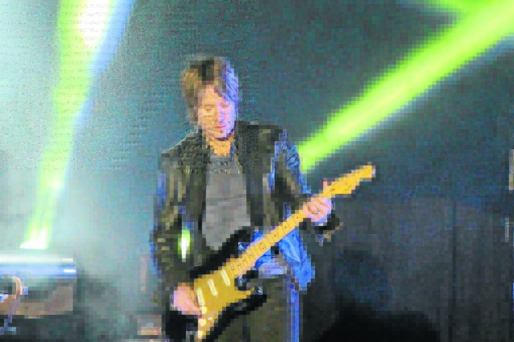 FIRING UP: Keith Urban warmed up the chilly conditions in Collins Park, Narrabri, on Friday night, with his hot guitar playing and singing. Photo: Rebecca Belt