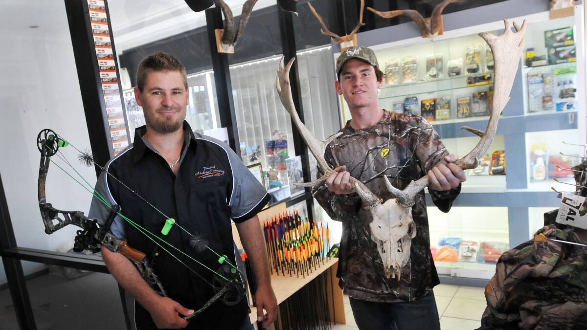 AIMING TO PLEASE: Tamworth Archery and Hunting owner John Hull and sales assistant Julian Bennic say patronage at the new store has outstripped expectations. Photo: Gareth Gardner 010414GGE01