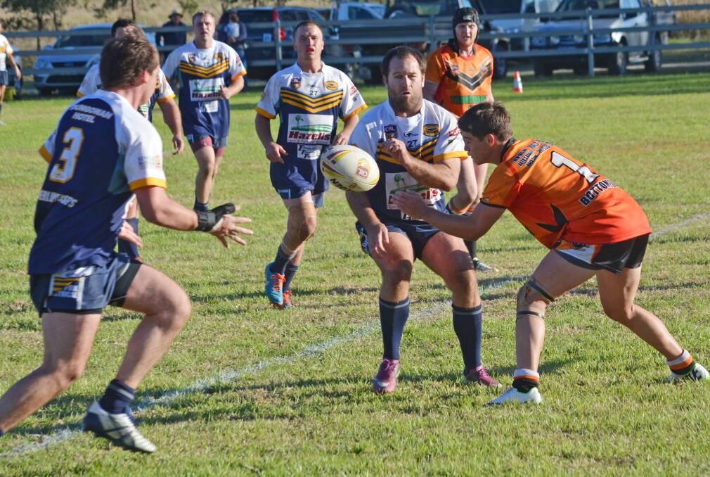 Shaun Ferguson sends one flat to Zander Smith who scored a double in the Cowboys’ win over Uralla at home on Saturday. Jordan Press is the tackler and was one of the Tigers’ best. Photo: Chris Bath 090515CBA12