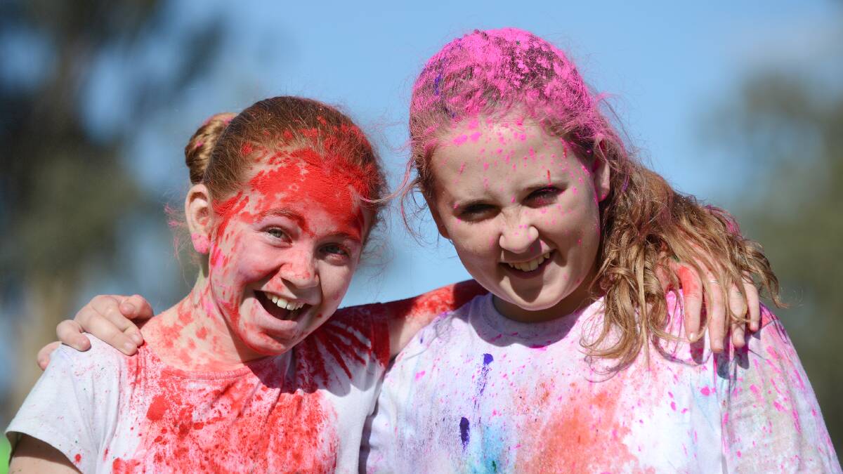 COLOUR COORDINATED: Georgia Byrnes and  Lucy Bowden were happy to be coloured in during the weekend fundraiser.   Photos: Barry Smith  170514BSE12