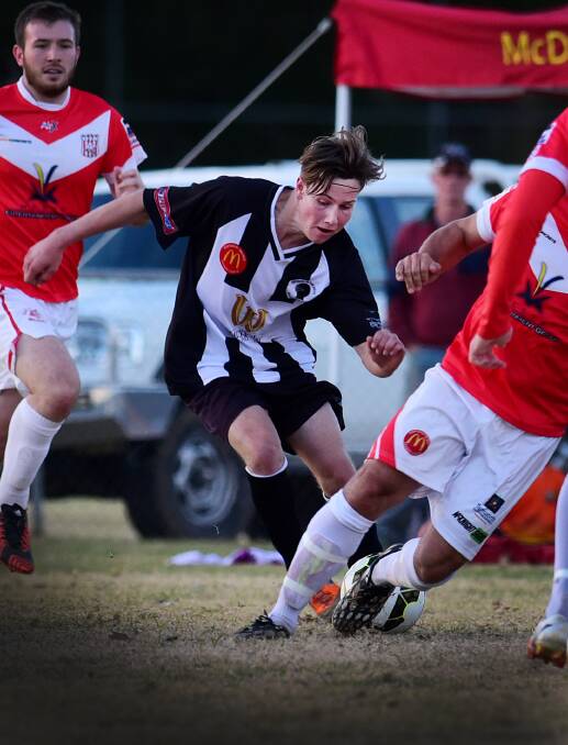 Young Demon Knight Callan McGregor tries to weave his way through the OVA defence in Saturday's 5-nil loss. Photo: Gareth Gardner 130615GGH08
