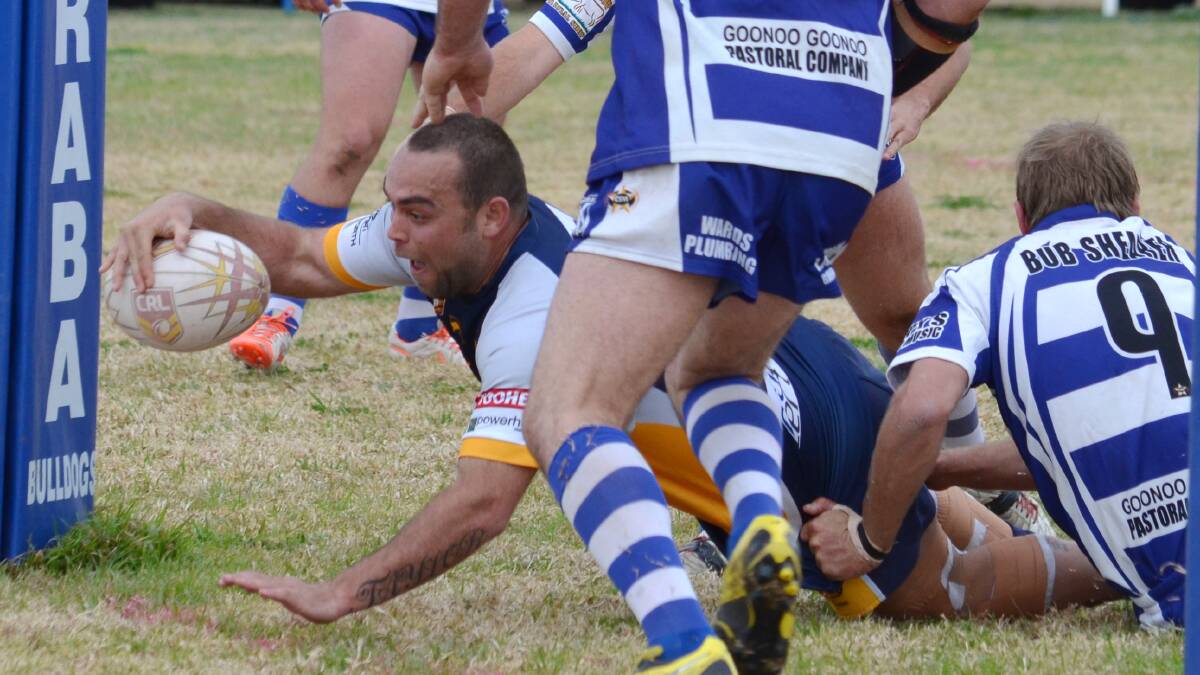 Dungowan coach Luke 
Taylor cracks a smile after cracking the Barraba defence and reaching out for his first of two tries. It wasn't enough, 
however, as the 
Cowboys got run down by the 
premiers in the closing stages. 230814CBA05