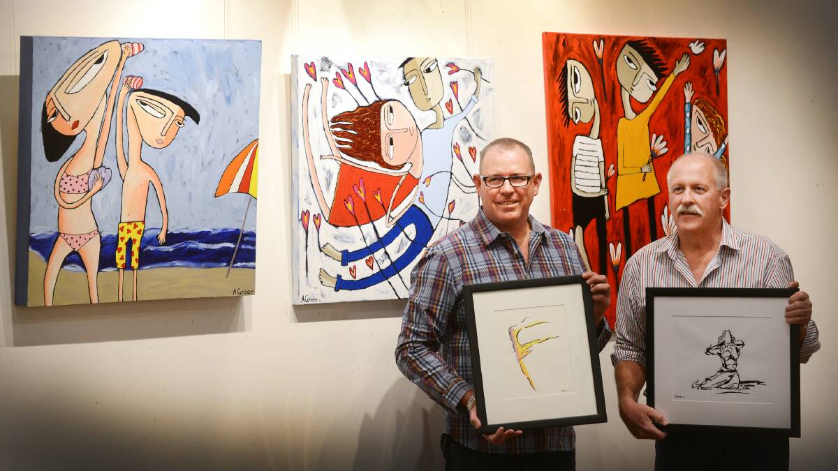 ARTISTIC EYE: Artist Andrew Greer and Weswal Gallery owner Ian Mason with some of the works in Andrew’s first exhibition, now on at the gallery until June 30. Photo: Barry Smith 140514BSA01