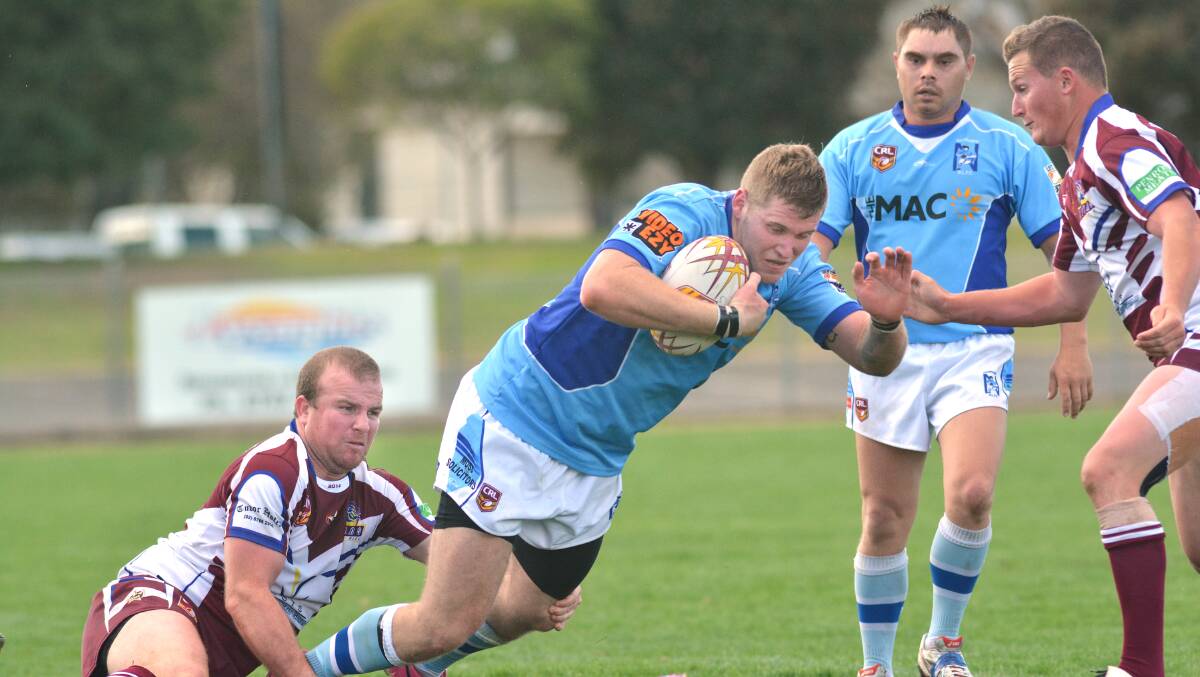 Narrabri second-rower Brendan Davey about to hit the turf in this Phil Beaton tackle as Tom Hine (right) moves in to finish the Blues backrower off. Five-eighth Normie Lawler looks on. Photo: Barry Smith 310814BSD32