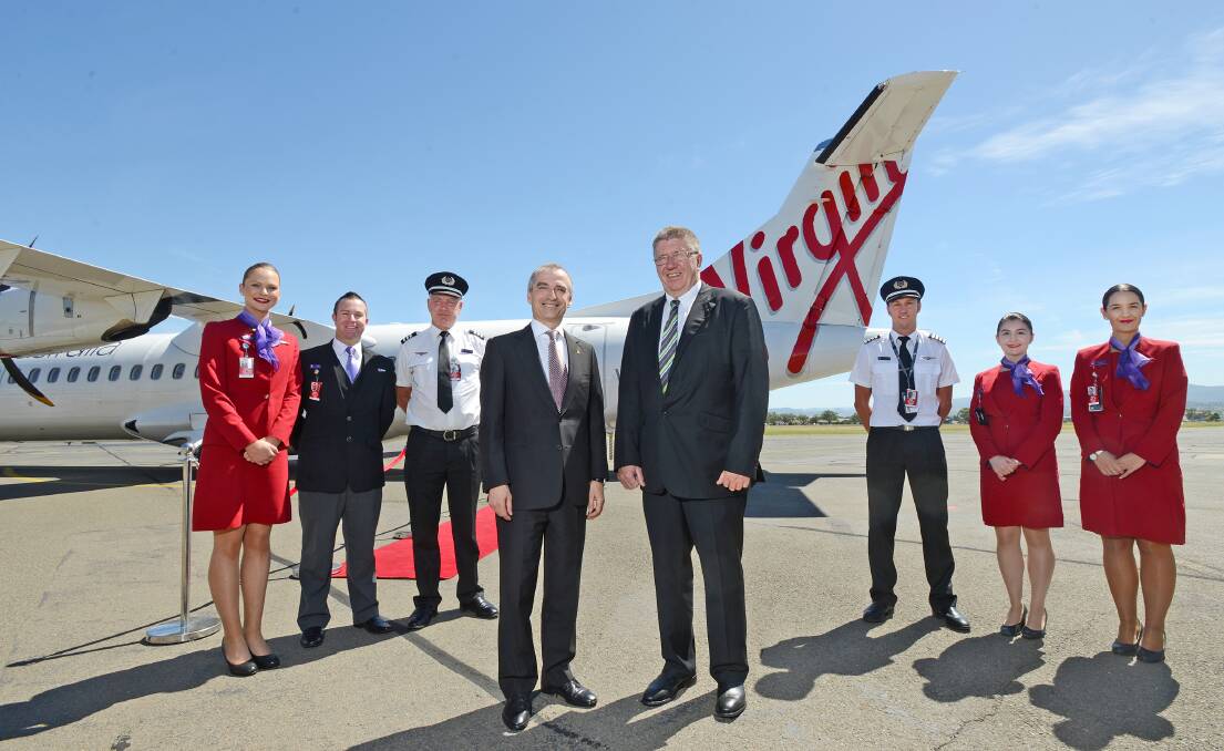 NEW PLAYER: Virgin Australia chief executive John Borghetti and Tamworth Regional Council mayor Col Murray with flight staff at Tamworth airport 
yesterday. Photo: Barry Smith
