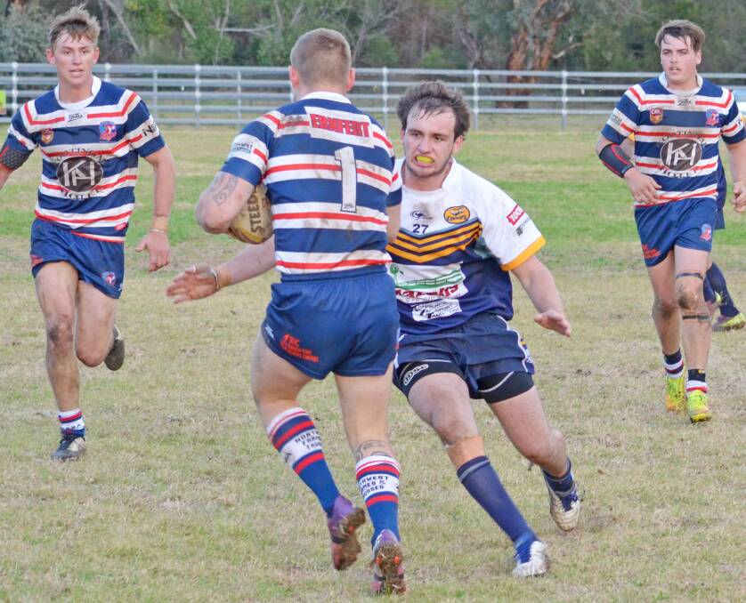 DUNGOWAN Recreation Reserve lit up on Saturday as an explosive grand final replay lived up to expectations when the Cowboys held on for a gripping 14-10 win over Kootingal Roosters.