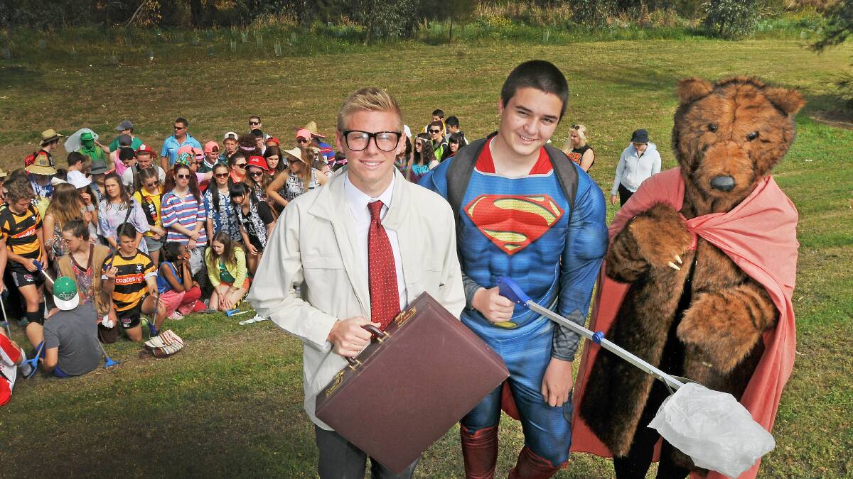 SUPER EFFORT: McCarthy students were joined by Superman (Lauchlan Walters), his alter-ego Clark Kent (Chris Ninness) and a helpful bear (Kathryn O’Sullivan) in their riverbank clean-up. Photo: Gareth Gardner  170914GGA02