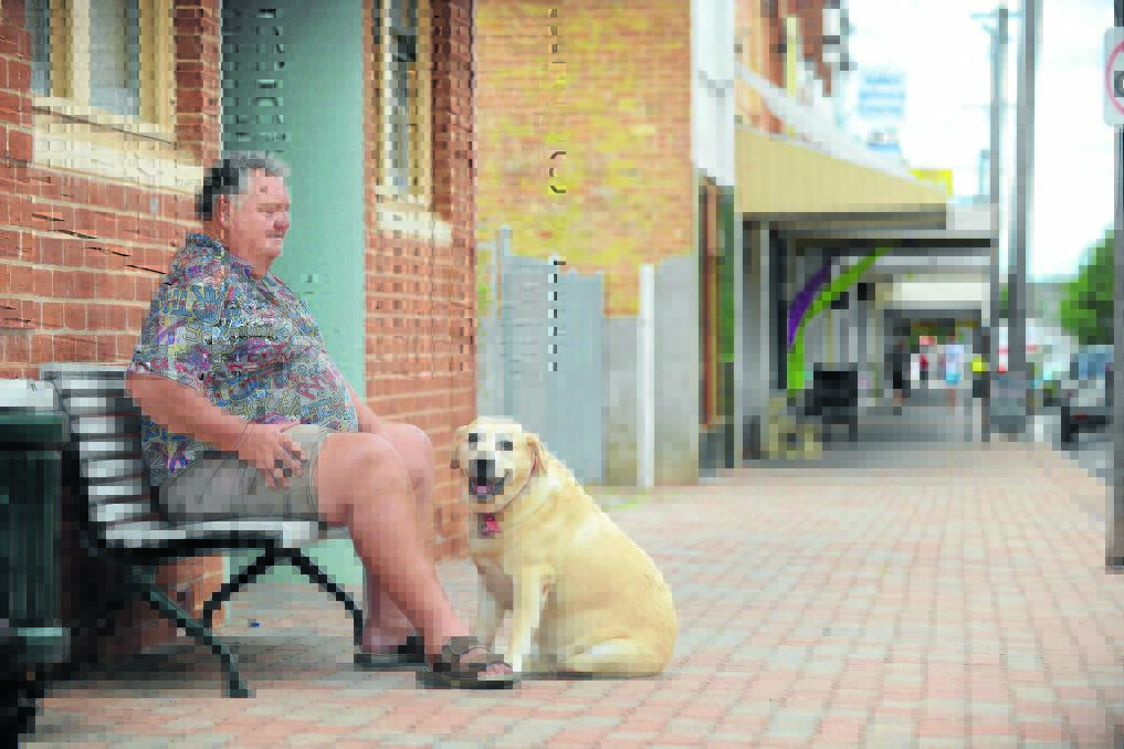 WAITING: There was nothing to do but sit for Manilla resident Paul Crowe and his trusted companion Buster in what was a very quiet CBD yesterday. 121214BSC12
