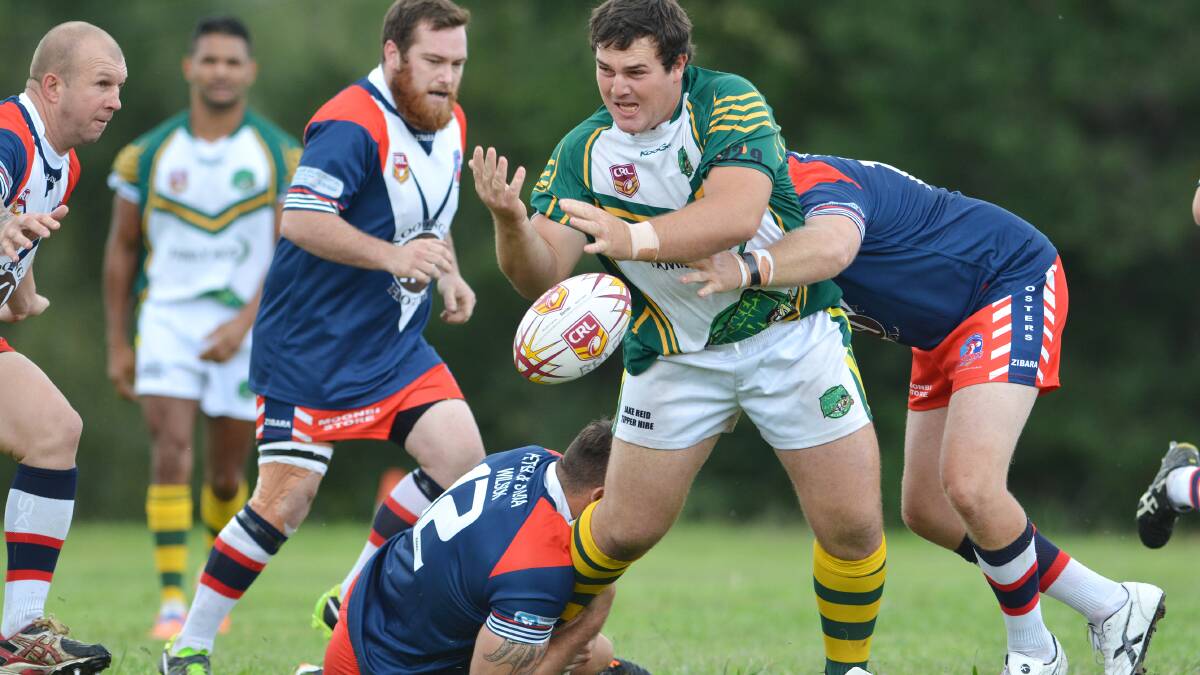 Bendy prop Rod Rolls tries to get this pass away against the  Kootingal Roosters in Saturday’s 34-24 loss.   Photo: Barry Smith 050414BSE05