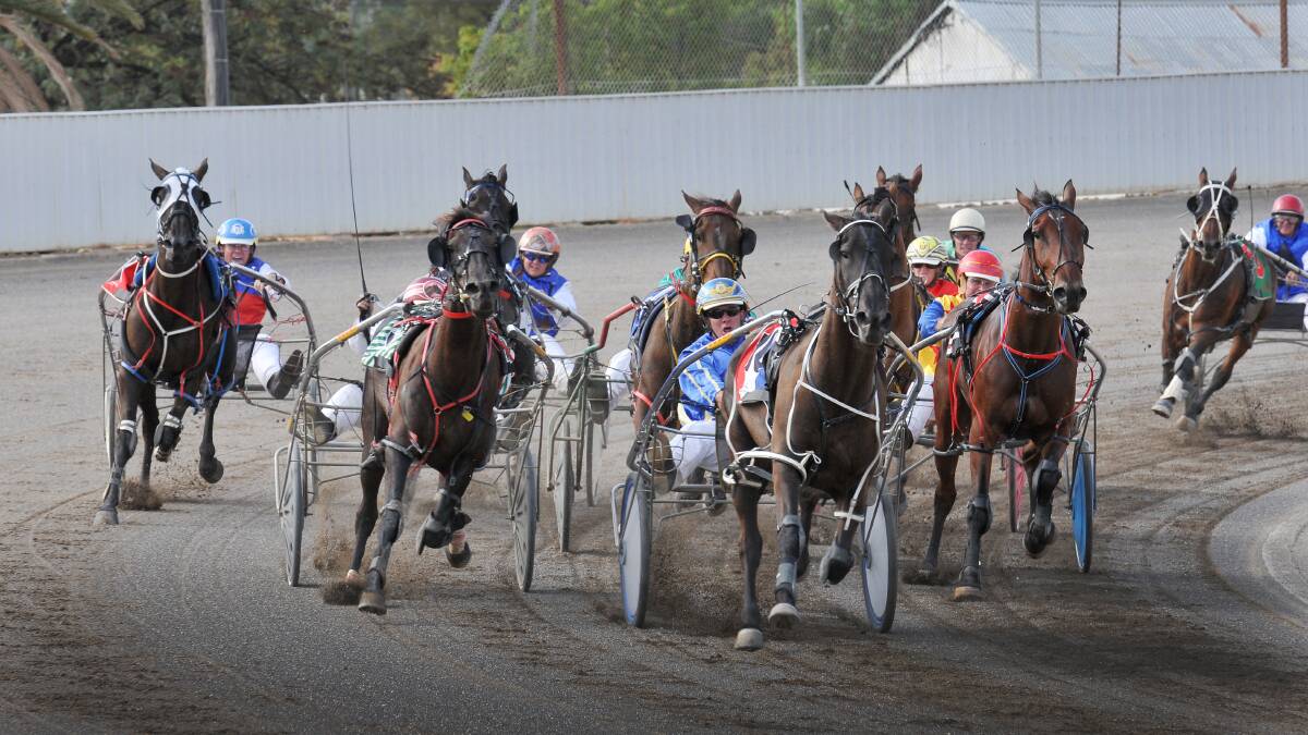 Peter Hedges and Leighmont surge home around the Tamworth Paceway home turn to win on Thursday for Tamworth trainer Ken Natty. 
Photo: Gareth Gardner  130214GGH07