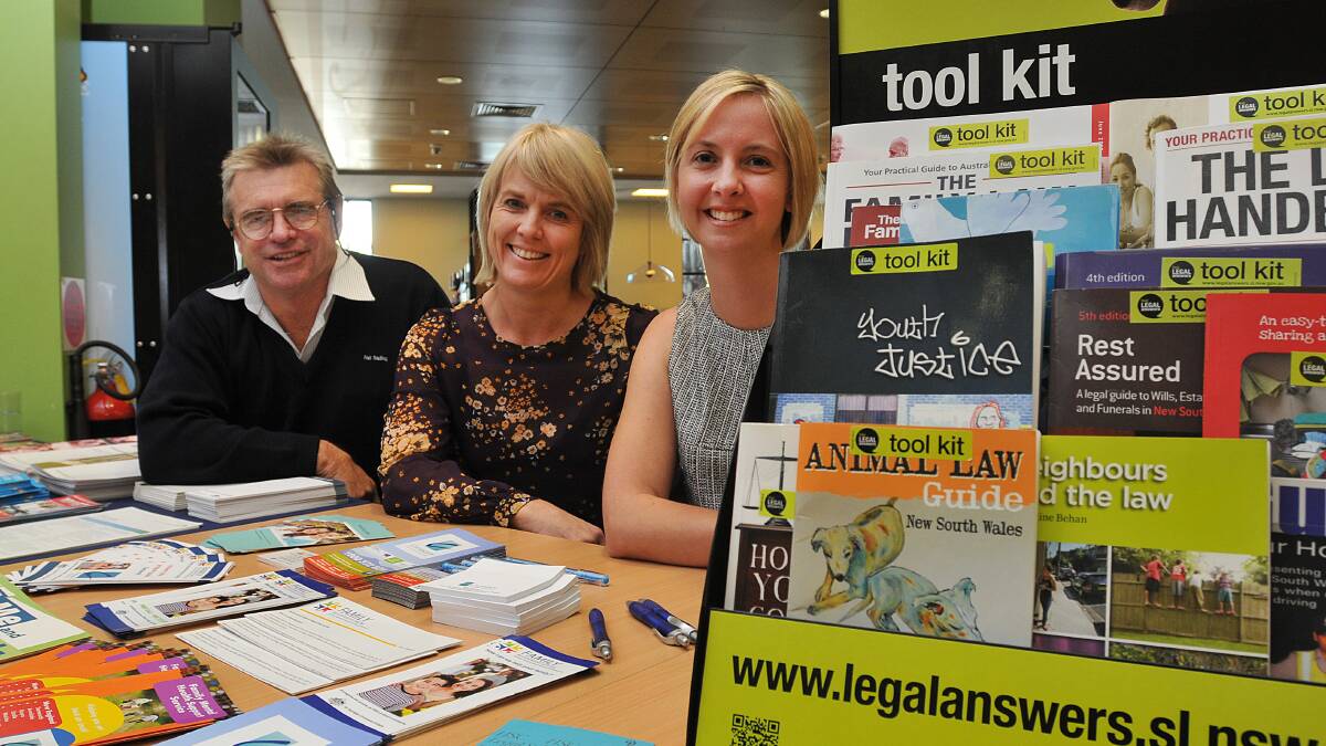ANSWERS AVAILABLE: Dale Higgerson (Department of Fair Trading), Kylie Boyraz (Centacare) and librarian Amanda Burke at the Law Week stand. Photo: Geoff O’Neill 120514GOC01