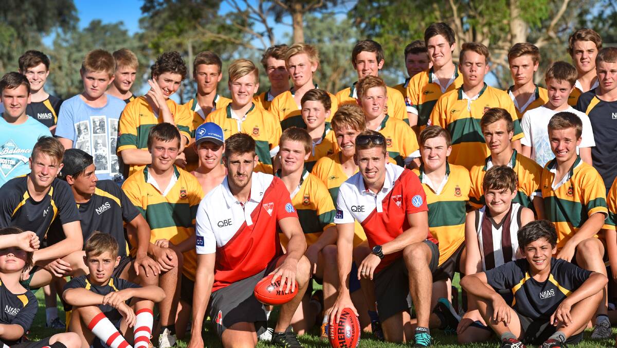 Swans Sam Naismith (left) and Jake Lloyd (right) pose with some of the Farrer and NIAS squads. Photo: Gareth Gardner 230215GGF01