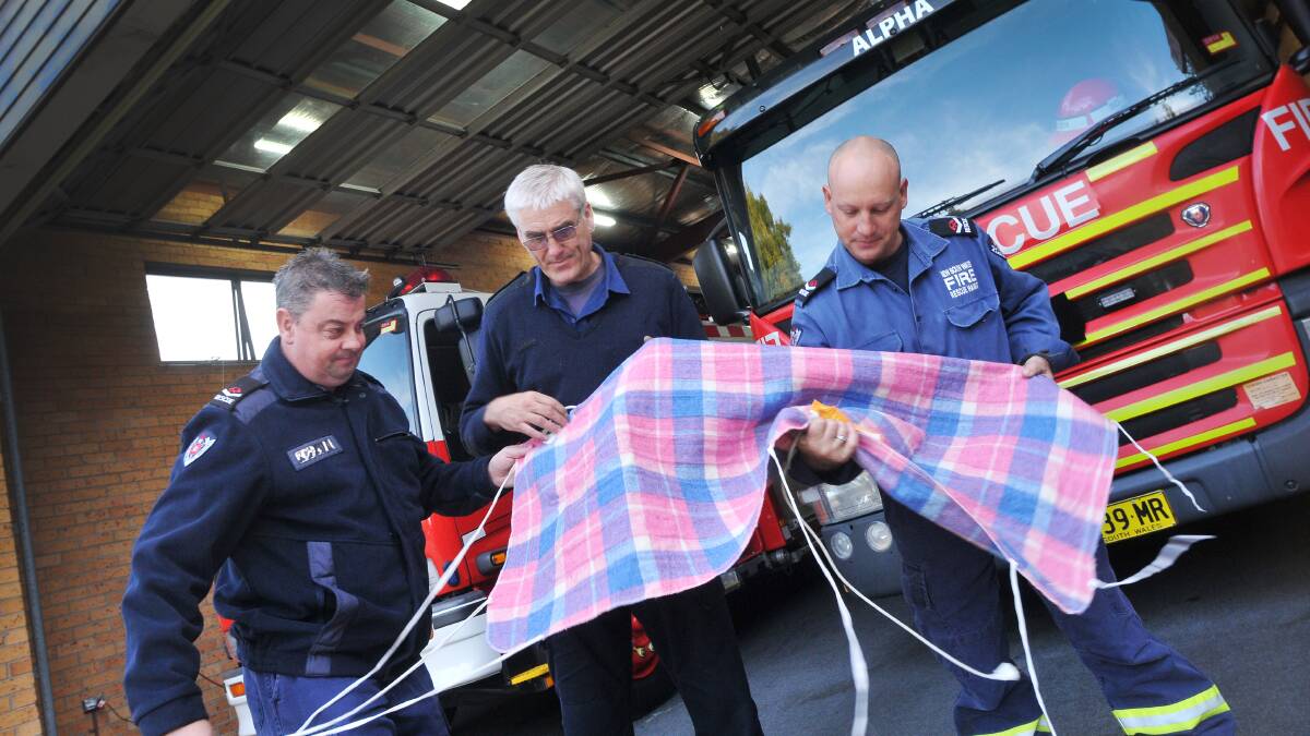 LESSEN FIRE RISK: From left, firefighter Andrew Coe, Tamworth Fire and Rescue station commander Phil Cox and firefighter Mark Stewart check over an electric blanket. Photo: Gareth Gardner 050514GGE02