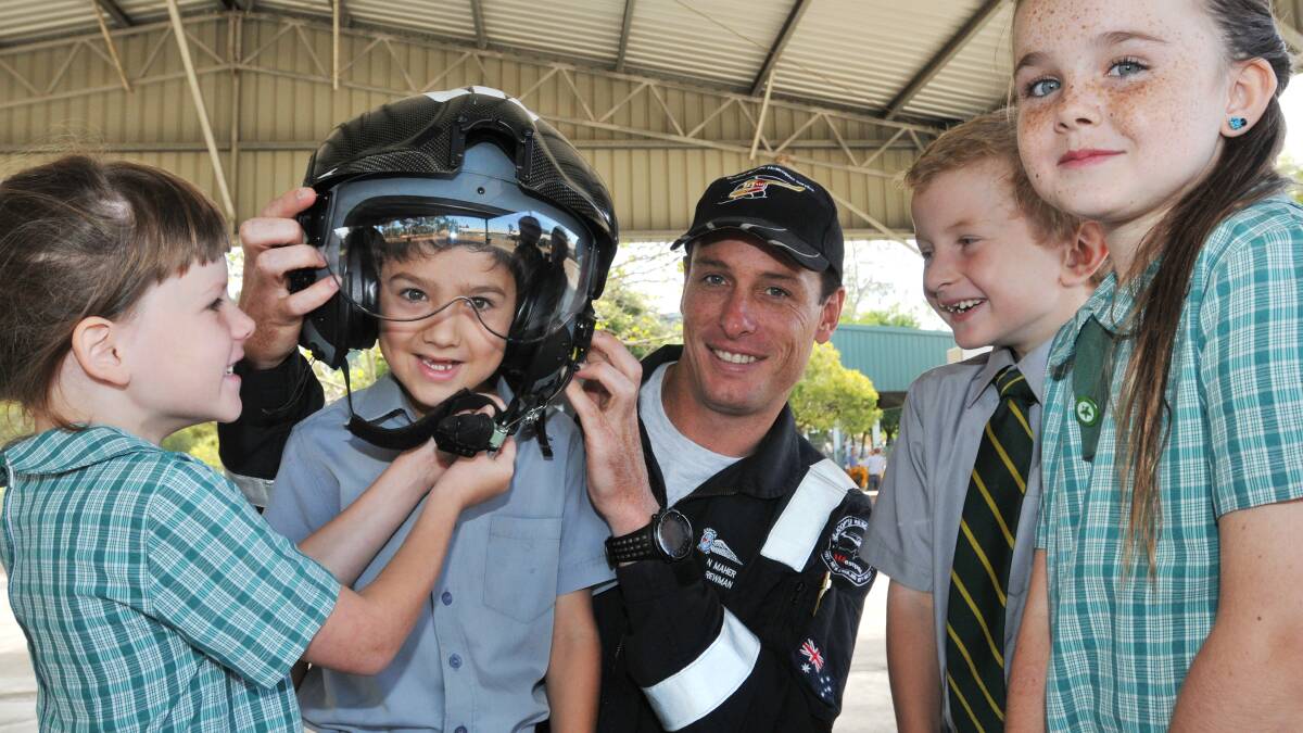 FUTURE OF RESCUE: Westpac lifesaver rescue program at Tamworth South Public with students Gabby Ward, Bayley Sunderland, James Scott, and Kiara Bourke learning about the helicopter from crewman Sean Maher.
Photo: Geoff O’Neill 200314GOA01