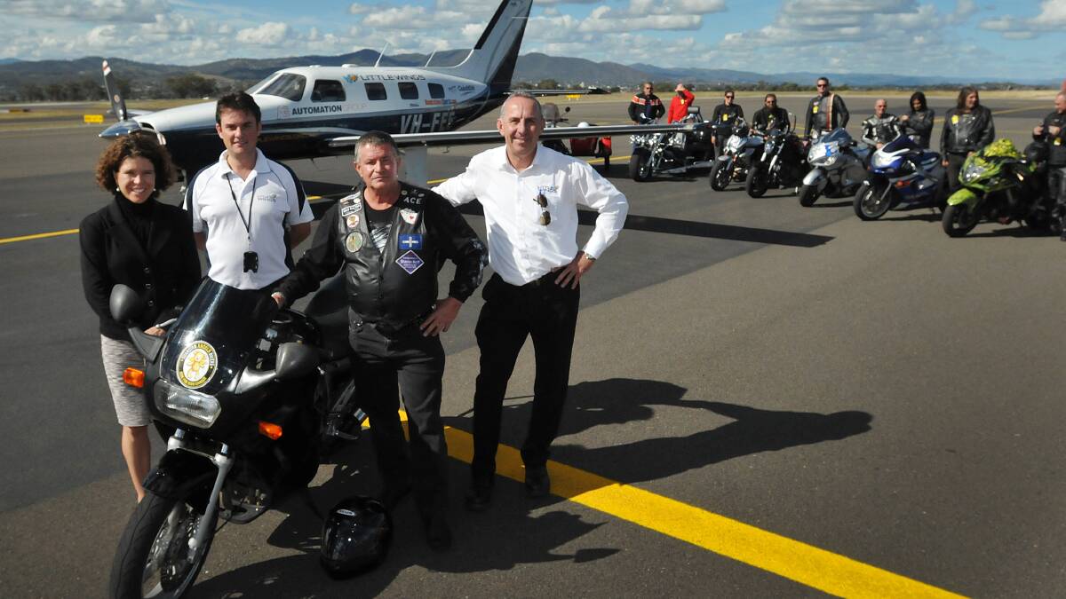 TAKING FLIGHT: From left, Emma Coombes, Adrian Nisbet, Adrian Simshauser (Ace) and Kevin Robinson at Tamworth Airport yesterday with some of the motorcyclists who are joining a poker run next month in aid of Little Wings. Photo: Geoff O'Neill 080514GOB02