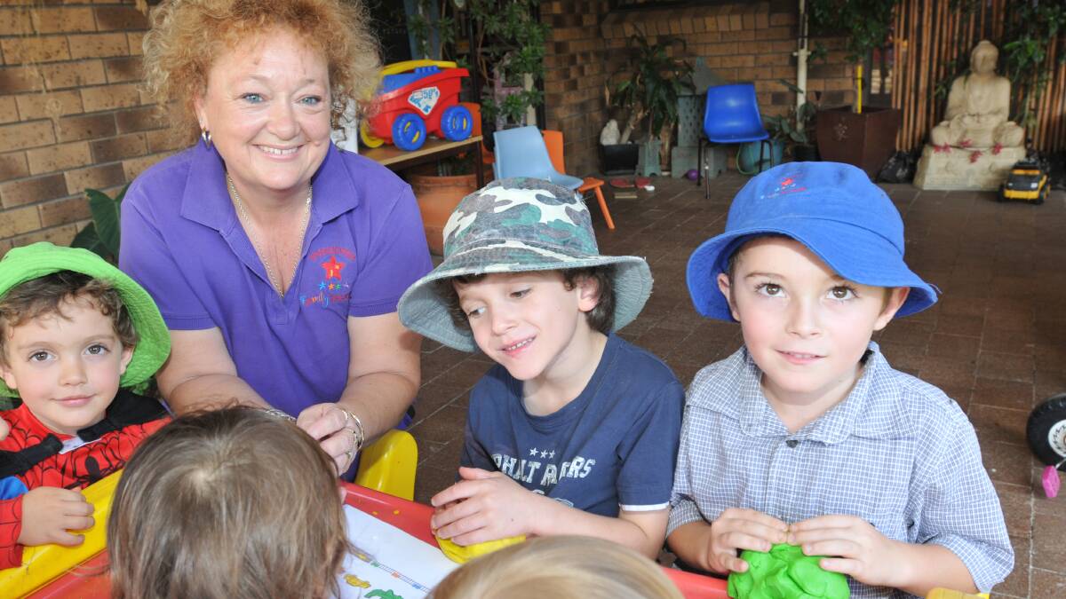NOMINATED AGAIN: Diane Watters has been selected as a state finalist in this year's Australian Family Early Education and Care Awards. She’s pictured with Baylen Wood, left, Coopa Davies and Jacob Cook. Photo: Geoff O'Neill 140414GOA03