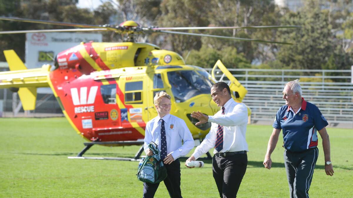 NSW CHS captain Luke Huth (left), NSW CIS skipper Tyrone Taukomo and Tamworth volunteer organiser Ron Surtees (right) arrive at Scully Park via the Westpac Rescue Helicopter Service chopper for the start of the Australian Under 15 Schoolboy Championships.  Photo: Barry Smith 220614BSD09