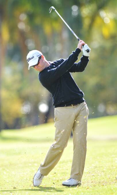 Tamworth Golf Club  treasurer Ben Lockwood hits this iron shot during Sunday’s first round of 
Choices A Grade Championship play at Tamworth Golf Club. He fired a two over par 72 to trail young leader Nathan Mann by two shots entering this Sunday’s second round. Photo: Barry Smith 180514BSB01