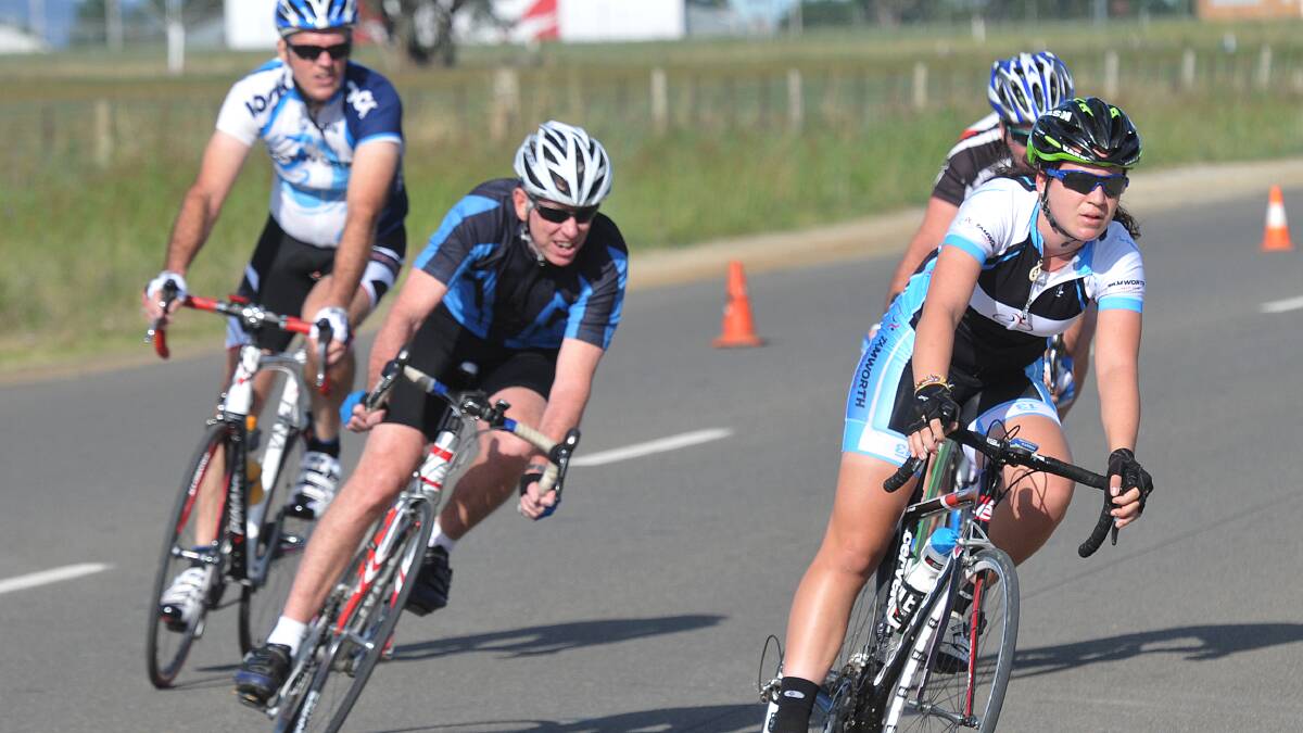 Jess Saunders leads Pete Nash, Darren  Taylor an an obscured Mal Nash into this turn on her way to a Tamworth Cycling Club C Grade Criterium championship on Sunday.  Photo: Geoff O’Neill 130414GOA04