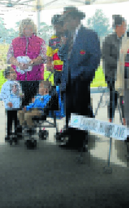 PROUD MOMENT: Lyall Munro snr, watched by mayor Katrina Humphries and the Munro family, speaks about having a street named after his late wife, Carmine.
