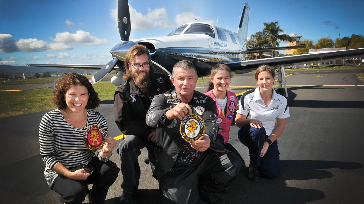 FUNDS WELCOMED: Emma Coombes, Guardian Angels Bikers Ben Doyle, Adrian Simshauser and Patricia Doyle and Little Wings pilot Sammi Booth. Photo: Gareth Gardner 280814GGC01