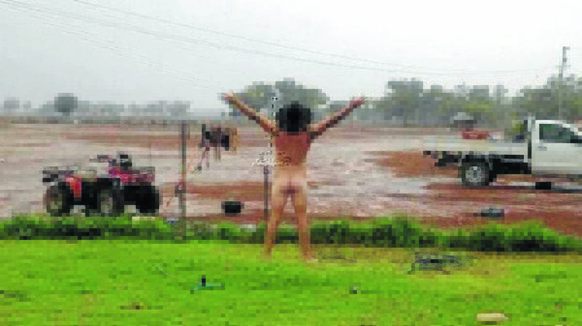 CELEBRATION: James Rogers has caused a furore on Facebook with his naked celebration of rain near Cobar. Photo: Jody Frazer
