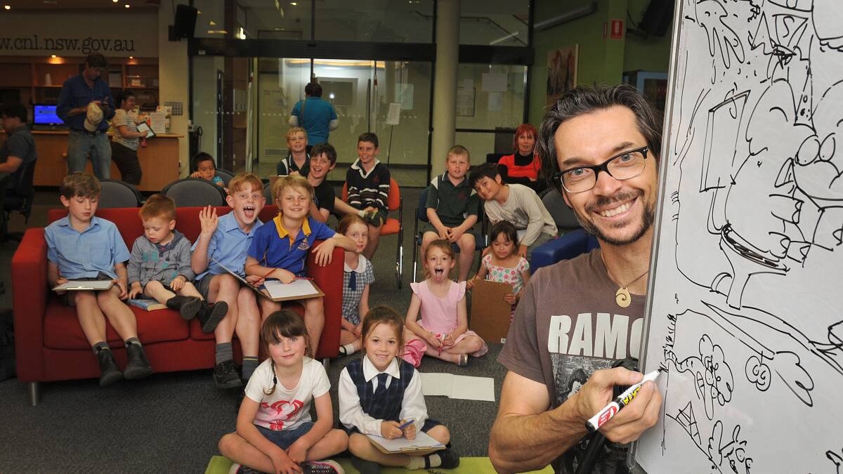 MAN BEHIND THE PEN: Children’s favourite Cartoon Dave worked his magic at Tamworth Library this week. Photo: Geoff O’Neill 160914GOF01