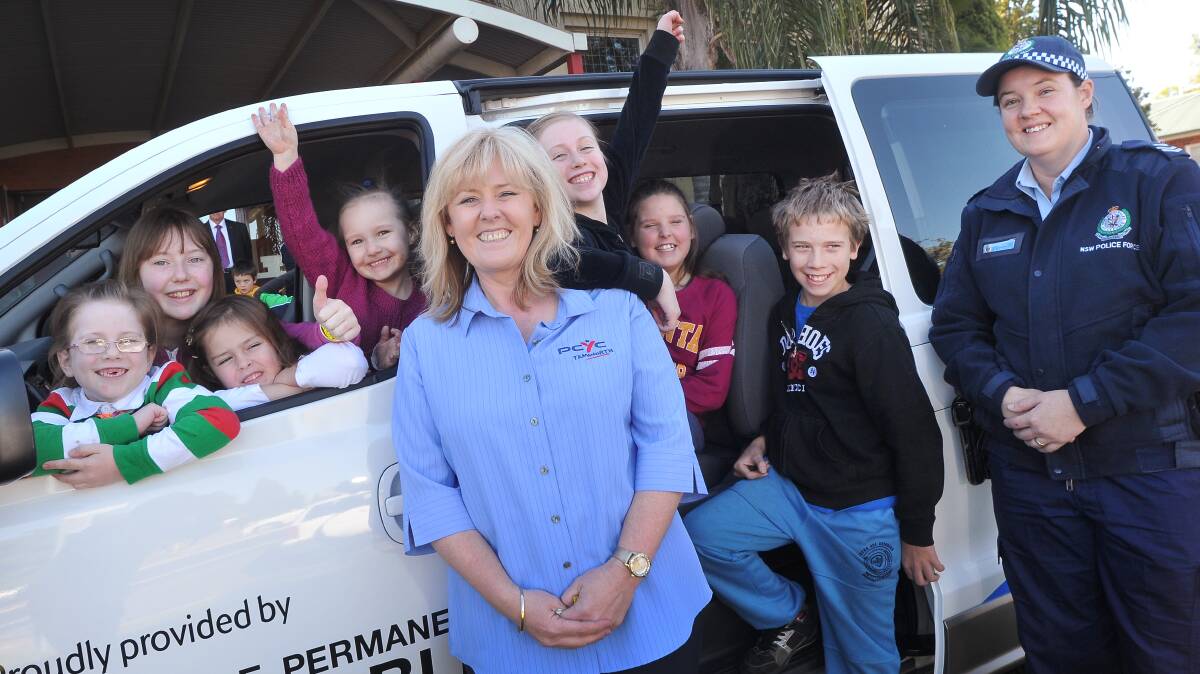 NEW WHEELS: The PCYC is excited to receive a new van. Front window, Bella Fox, Makayla O’Leary, Zahlee Betts and Amber Smith; back window, Lily Fox, Katelyn Butler and Noah Campbell, and front, Kylie O’Leary and Andrena Sandison. Photo: Gareth Gardner 030714GGC02