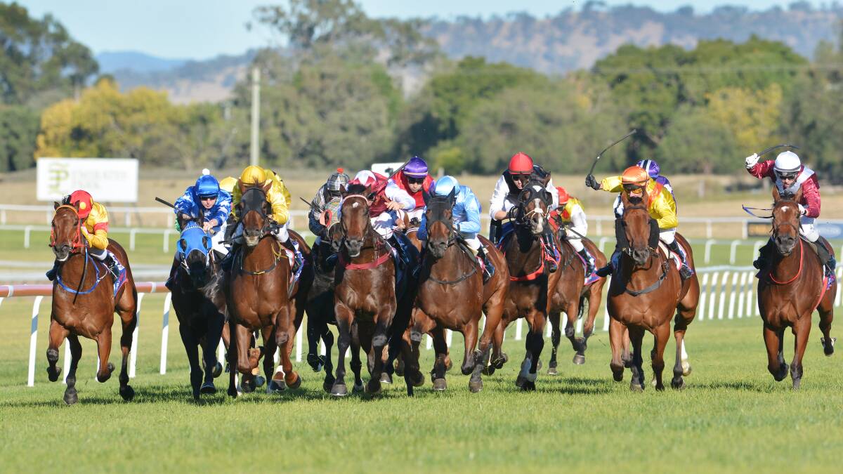 Tail Risk (sky blue fourth from right) comes through the middle to win the Dane Shadown @ Kitchwin Class 2 Handicap (1300m). Sam Clipperton was the jockey and went on to win the Scone Cup in the next race.  Photo: Barry Smith 160514BSC02