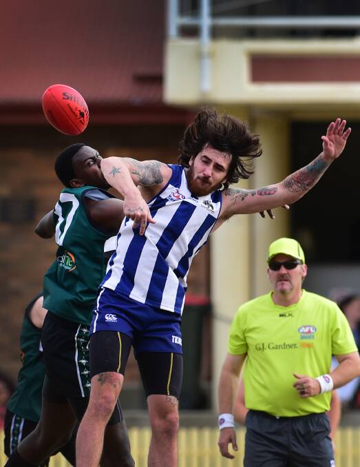 Tamworth Roos ruckman Ryan Painter (front) and New England Nomads big man Omphile Temoso go at it last Saturday. Temoso and his Nomads celebrate that win with a home game against Inverell Saints tomorrow while Painter and his Kangaroos  will be out to  rebound against the Tamworth Swans at No 1 Oval Tamworth tomorrow.  Photo: Gareth Gardner  130615GGD05