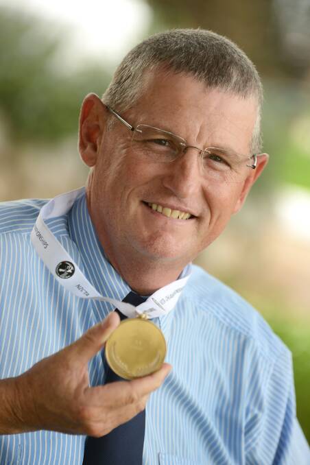 John Sleightholme and his NZ national silver medal that earned him a NSW Hall Of Fame berth. Photo: Barry Smith 040414BSB01