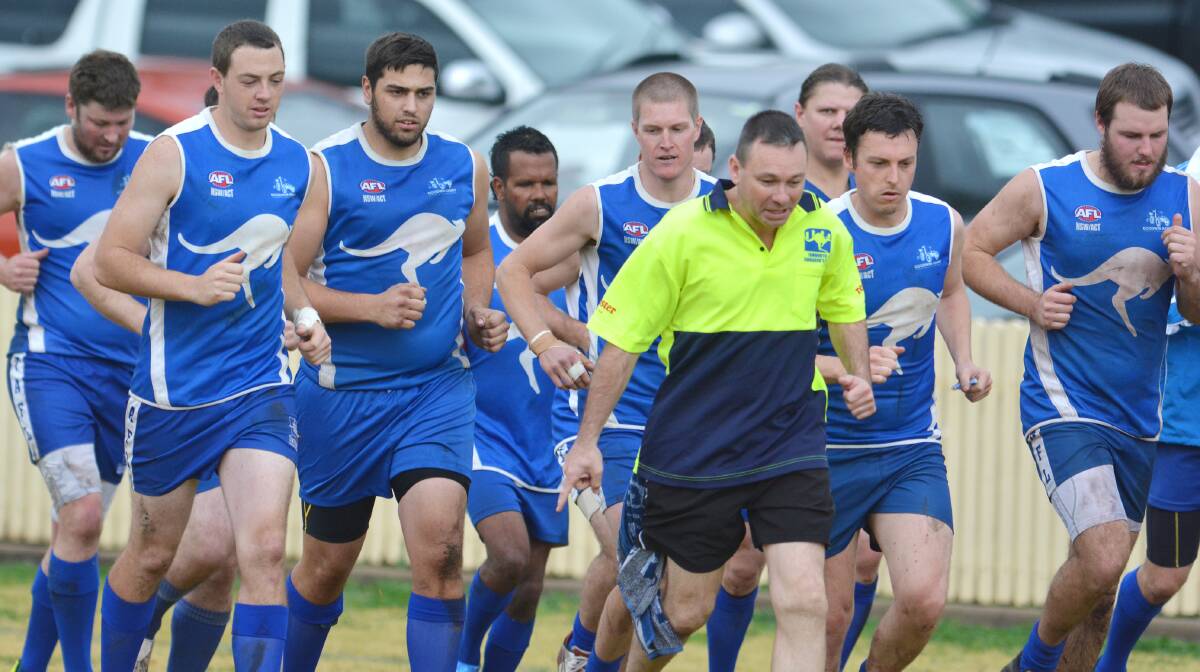 Tony Bishop helps the  Kangaroos warm up before a TAFL clash last year. He’s back as Roos coach and ready to go. See tomorrow’s Leader for his thoughts on a new TAFL season. Here he warms up (from left) Ian Clement, Carl Frazier, Drew Murden, Ben Kennedy, Luke Robinson, (Bishop), Matt Hopson, Chris Rankmore and Brad Rees at halftime of a Gunnedah match last July.  Photo: Barry Smith 260714BSF01