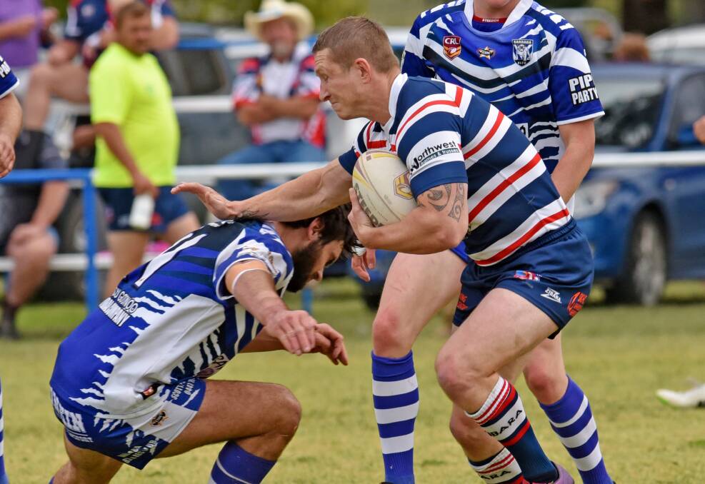 Kootingal fullback Jeremy York braces for this tackle by Bulldog second-rower Zac Mallise in yesterday’s Rooster rout. Photo: Geoff O’Neill 030515GOE04