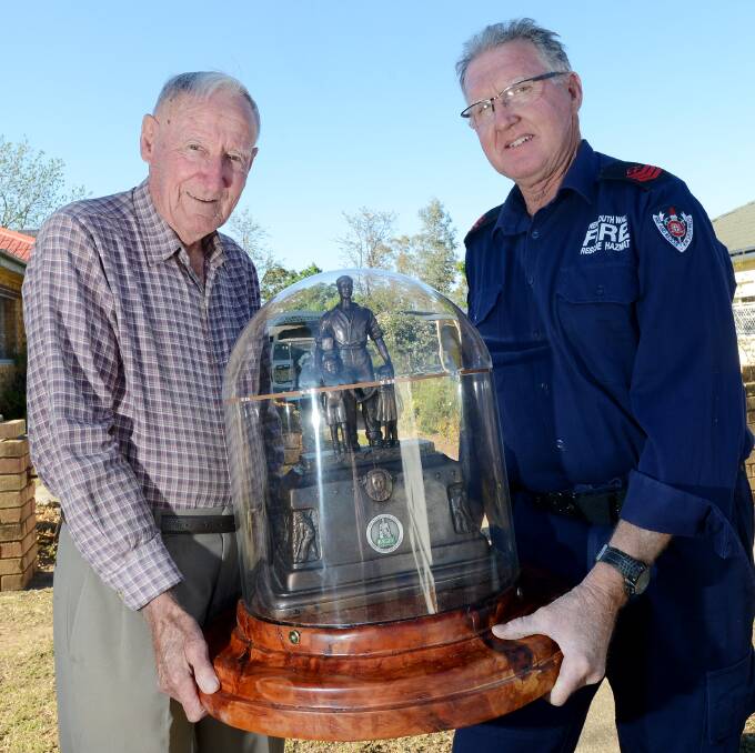 HEAVY DUTY: Ron Young, left, and Rob Eckersley load up the latest firefighting championship trophy for the trip from Tamworth to this week’s state Fire and 
Rescue titles near Bathurst. Photo: Gareth Gardner 161014GGH02