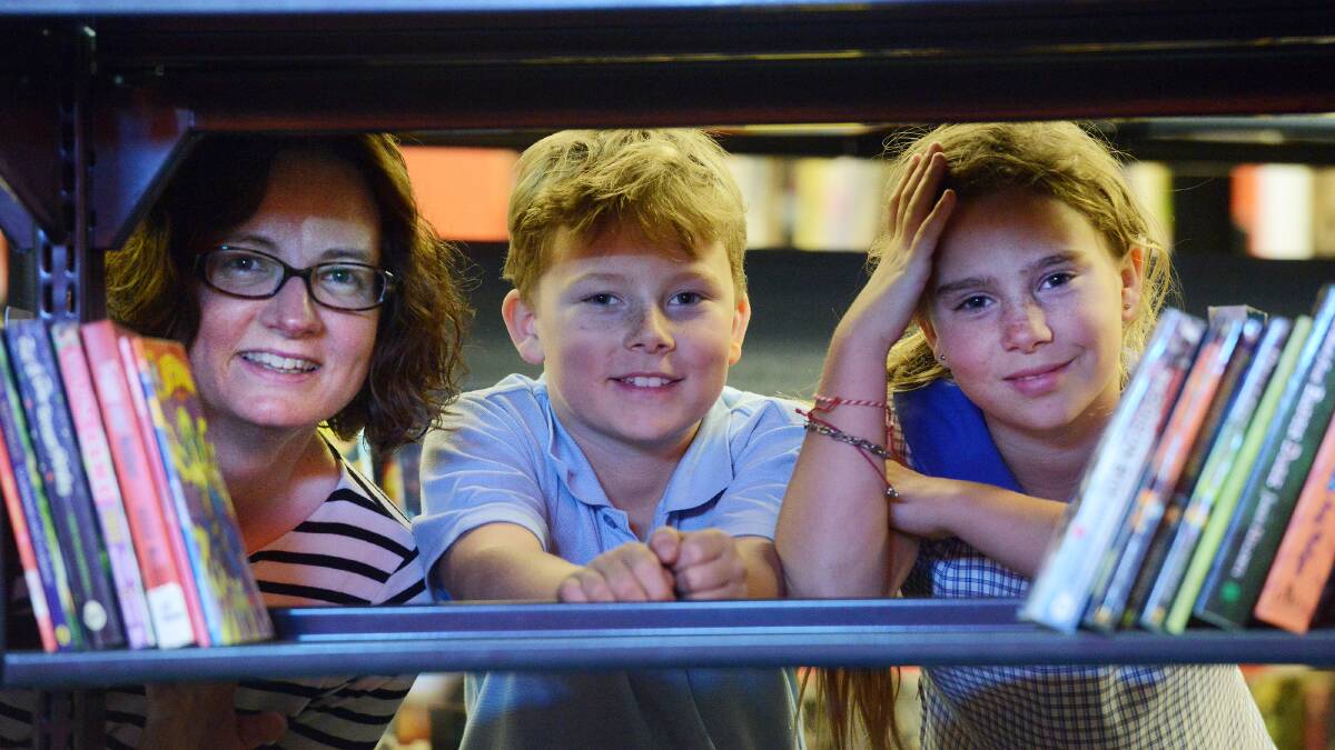 ALL BOOKED UP: Librarian Shiralee Franks, left, and siblings Beau and India Berg-Williamson are looking forward to the Tamworth Regional Library open day tomorrow. Photo: Gareth Gardner 221014GGL01
