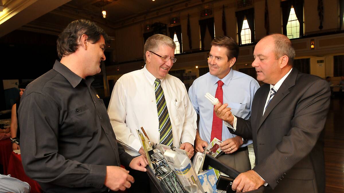 LIGHTBULB MOMENT: Essential Energy’s David Crough, left, shows Tam-worth mayor Col Murray, local MP Kevin Anderson and Wagga Wagga MP Daryl Maguire some simple ways to save money on their power bills at yesterday’s Bill Buster forum at the Tamworth Town Hall. Photo: Gareth Gardner 210314GGB01