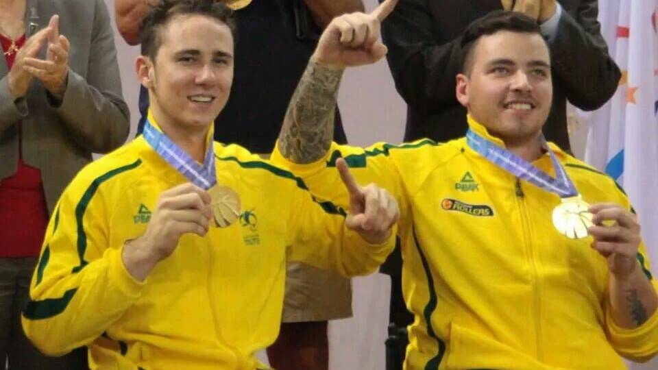 Tom O’Neill-Thorne (left)  celebrates his World Wheelchair Basketball Championships gold medal success with a teammate.