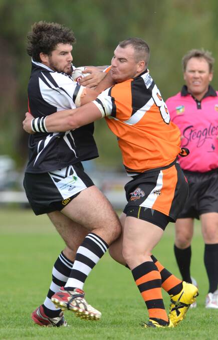 Werris Creek prop Thomas Brown (left) and Manilla captain coach Chris Vidler come to grips in Saturday's Group 4 
Second Division Shield clash. Brown and his Magpies won 58-6. Photo: Barry Smith  260414BSE23