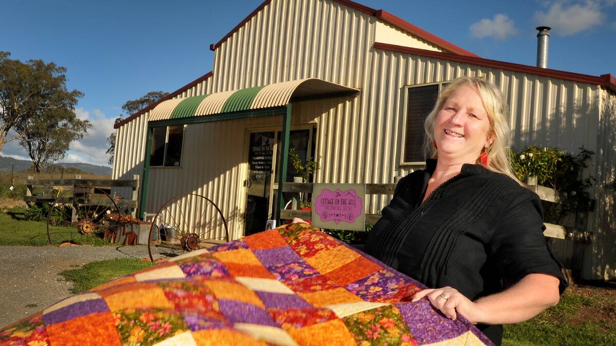 ALL STITCHED UP: Cottage on the Hill’s Kerry Swain is ready for the annual Airing of the Quilts for the Cancer Council today. Photo: Gareth Gardner 080514GGB01