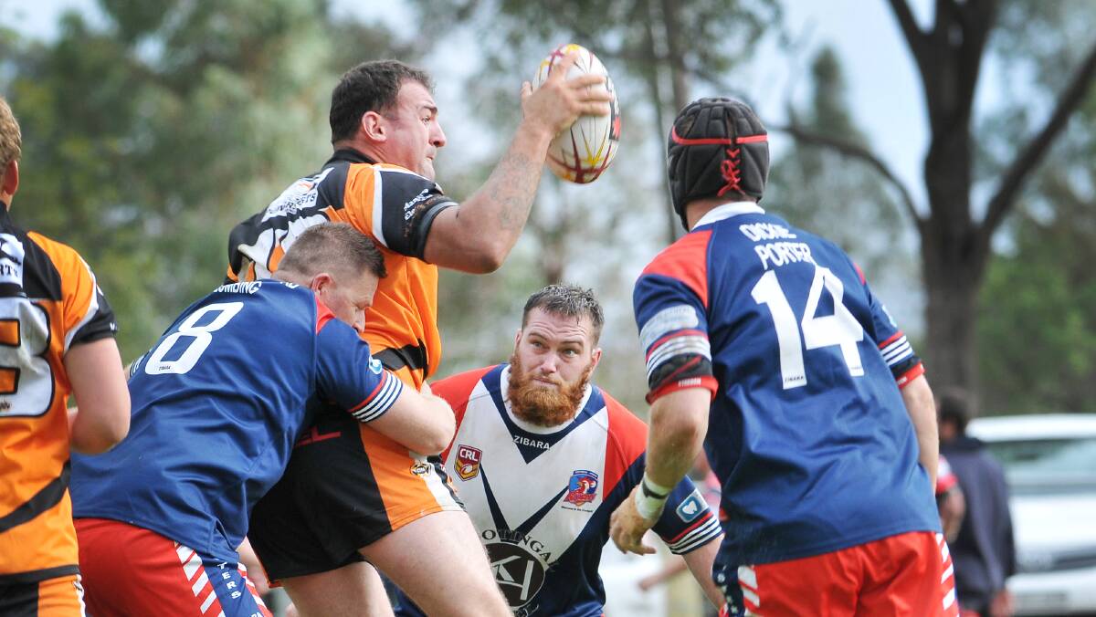 Manilla prop Daniel Fawkes stands firm against  Kootingal Roosters  Ryan Moore (8), Grayson Bradbery (beard)  and Dane Greenwood (14). Manilla plays Barraba  tomorrow while the Roosters are at Dungowan. Photo: Gareth Gardner  030514GGD12