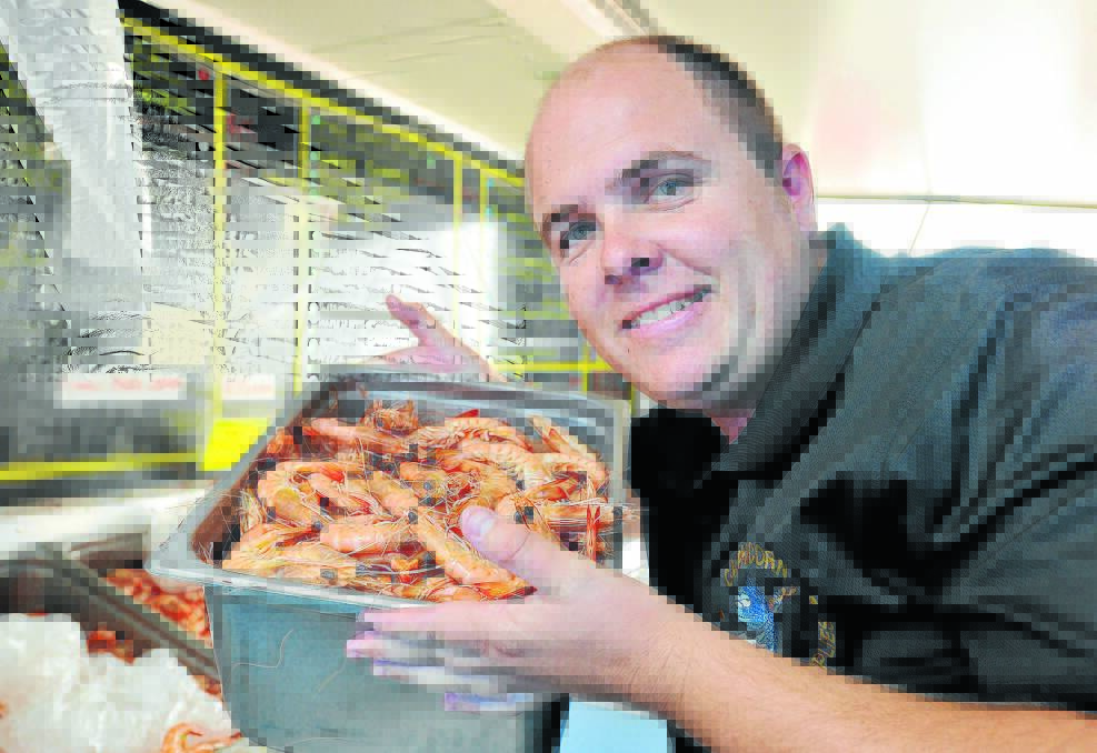 FISH FRENZY: Paul Hynes, of Capricorn Seafood Supplies, will sell about 1.5 tonnes of prawns to Tamworthians in just two days in the lead-up to Christmas. Photo: Geoff O’Neill 231214GOB01