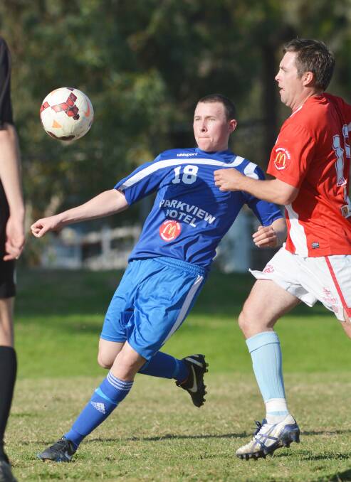 Harley Cheetham (left) was the Gunnedah United Players’ Player Award winner. Here he  battles with Oxley Vale Attunga’s Ben Genardini. Photo: Barry Smith 300814BSF33