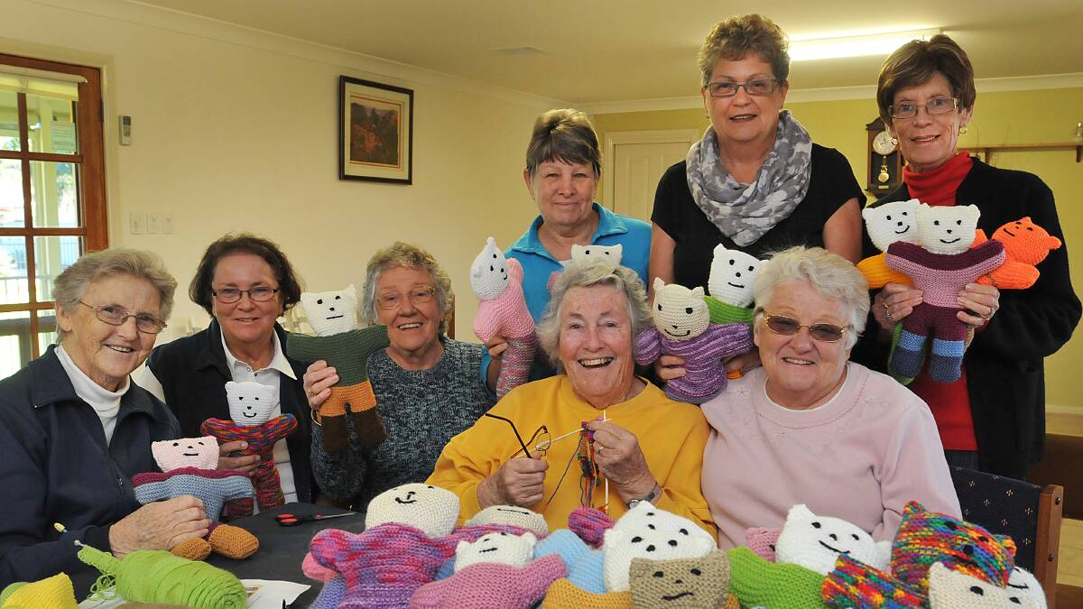 TEDDY BEAR CENTRAL: Making up the trauma teddy production line, at front, is Lorna Sweeney, Margaret Dunn, Morna Taylor, Hilary Howell and Peggy Holzigal. At the back, Dawn Wood, Jill Gay and Kerry Cannon with some of the teddies they've made. Missing from the photo is teddy maker Margaret Ponifex. Photo: Geoff O'Neill 110614GOB01