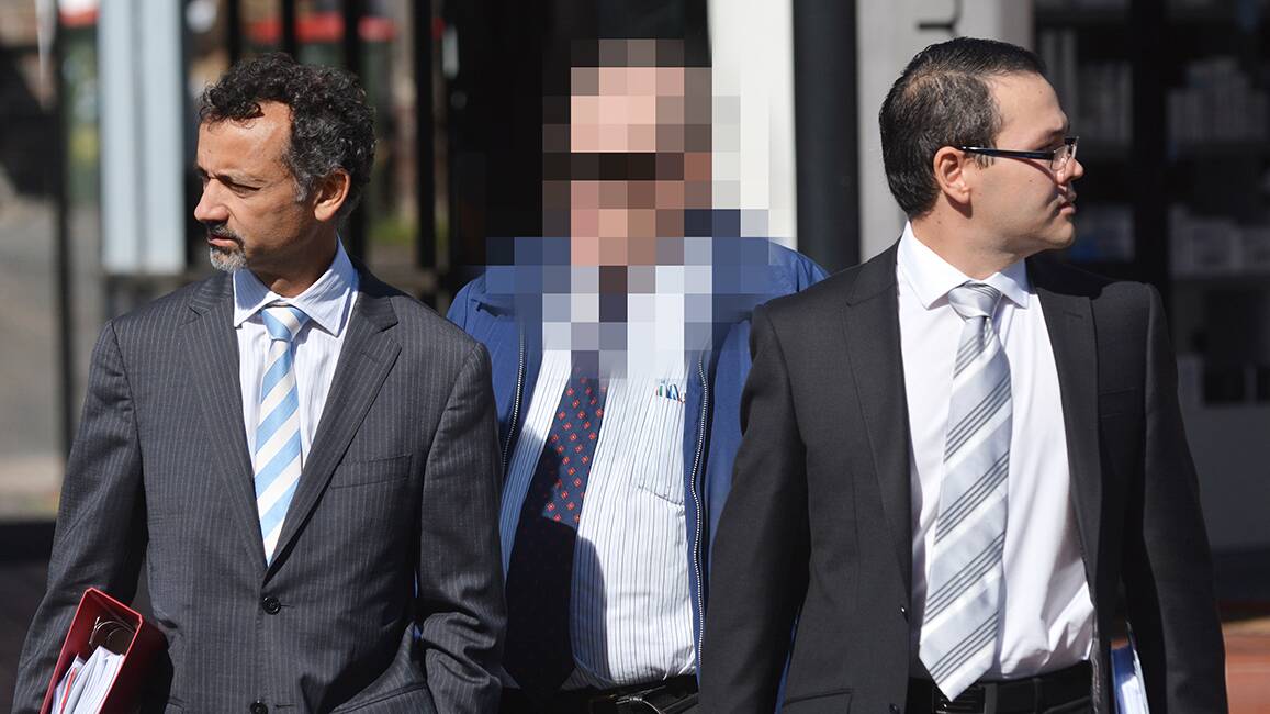 NO PLEAS: The defrocked priest who can’t be named, pictured middle, walks into Armidale Local Court yesterday, escorted by barrister Hament Dhanji, left, and solicitor Glen Kee. Photo: Barry Smith 090414BSB02