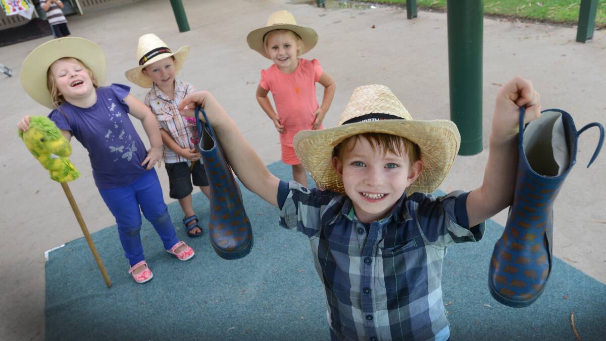 FARMERS FOR A DAY: Hudson Stout, 4, with his gumboots and Stella-Grace Dean, 5, Lewis Crough, 3, and Ebony Peperall, 3, behind.  Photo: Barry Smith 070314BSB02