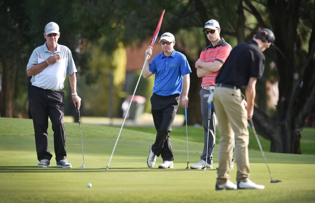 Talented young Tamworth golfer Tom Gill putts out during last Sunday’s second round of the  Tamworth A Grade Club Championships. Watching are (from left) Wayne Turner, Ben Lockwood and Rob Studte. The final two rounds will be held this weekend.  Photo: Barry Smith  170515BSG28