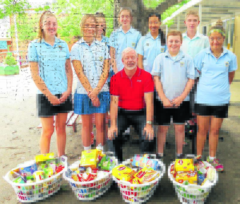 SPIRIT OF GIVING: THS students with hampers they presented to the Salvation Army’s David Rogerson. From left, Katie Robinson, Chloe Allwell, Jessica Berman, Sarah Wood, Maree Vongphachan, Luke Berman, Joshua McCulloch and Hollie Taggart.