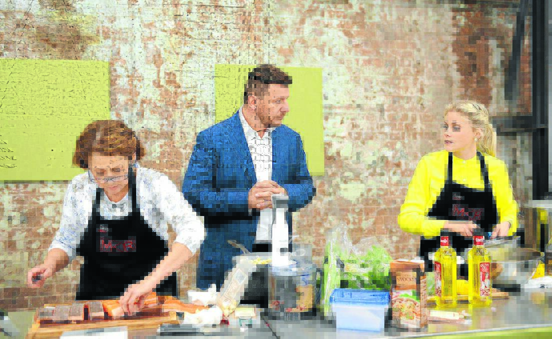 HEAT IS ON: Walcha mum and daughter Cathy, left, and Anna Lisle, right, cook for their reality TV lives while judge Manu Feildel looks on during a recent episode of My Kitchen Rules.