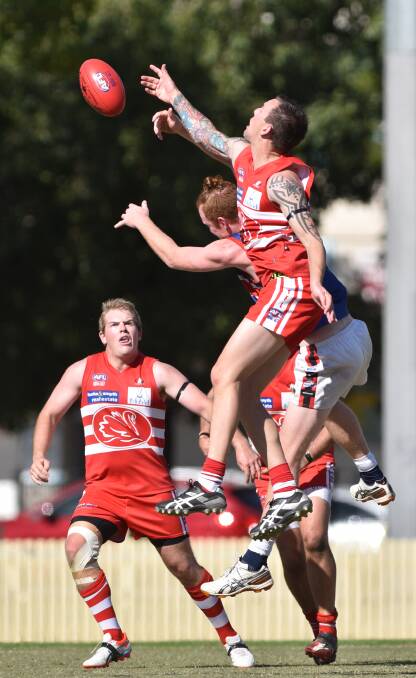Swans star Adam Splithof climbs high to win this contest against Gunnedah’s Jacob Bee-Gill as Swan James Dunston waits to pick up the crumbs. Photo: Barry Smith  110415BSC24